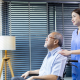 Comfort Home Care Services caregiver assisting an elderly man in a wheelchair while looking out the window at home