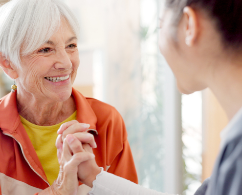 a happy senior woman with caregiver giving her a companionship care in preston
