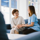Trained carer using dementia communication training techniques to connect gently with an elderly woman at home