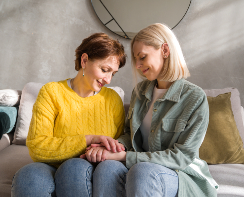 Specialist carer supporting an elderly woman at home, demonstrating the value of dementia specialist training