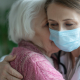 A specialist home carer providing support to an elderly individual, demonstrating the clinical standard of dementia training for nurses in a home care setting.