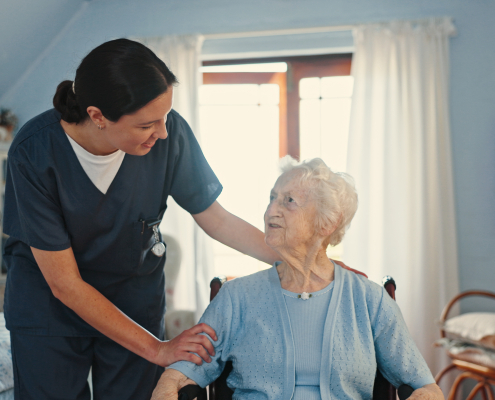 A professional carer supporting an elderly woman at home, illustrating home care for the elderly in Lancashire