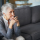 A carer providing support for elderly living at home, sitting with an older woman in her living room in Lancashire