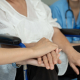 Caregiver supporting elderly patient in wheelchair, concept of resources for carers and senior care